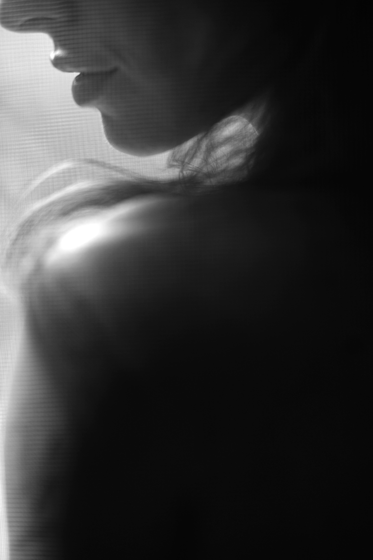 Soft light on lips, chin, and shoulders